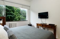 Bedroom with double bed and TV.